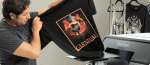 Black T-shirt with vibrant carnival graphic and bold text.