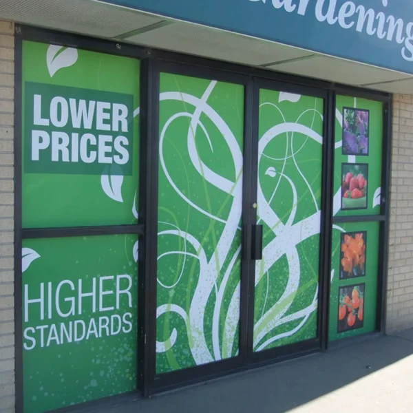 Storefront displays signs promoting lower prices and higher standards.
