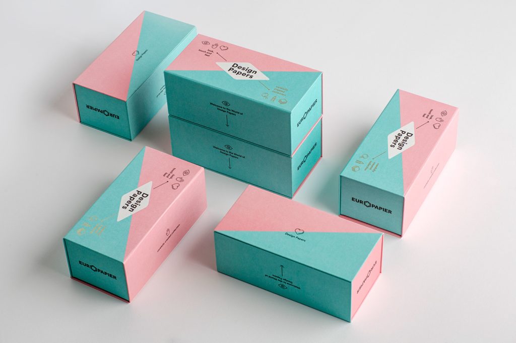 Pink and teal geometric gift boxes with elegant floral designs.