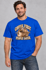 Model wearing royal blue Coffee First People Later graphic T-shirt with brown and cream coffee artwork